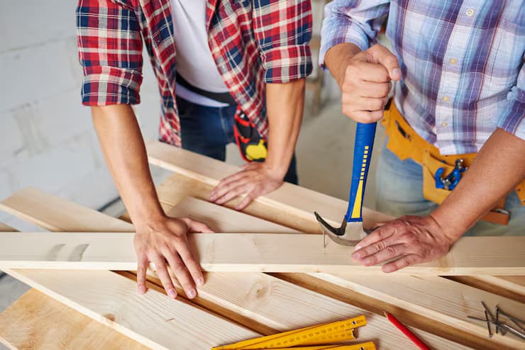 Carpenter installing a custom sliding wardrobe in a master bedroom