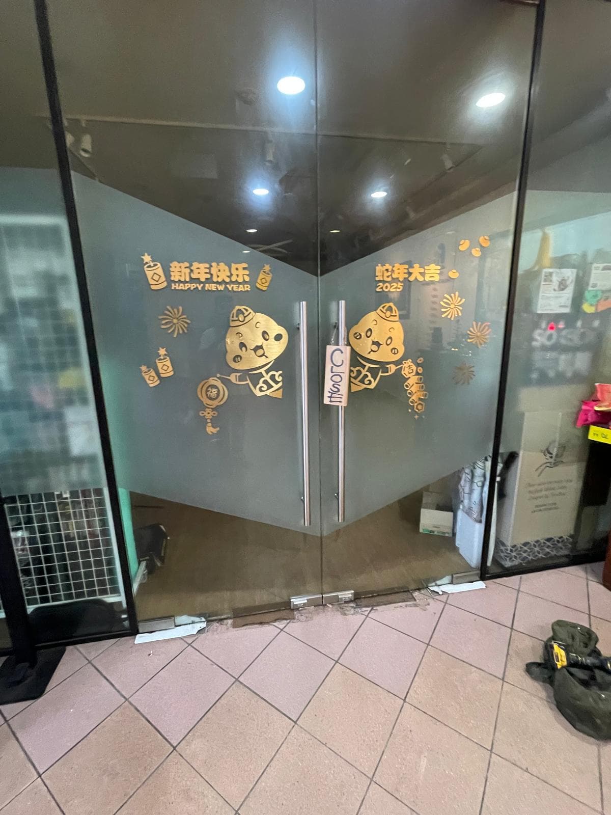 Technicians installing new glass on a retail storefront in Singapore