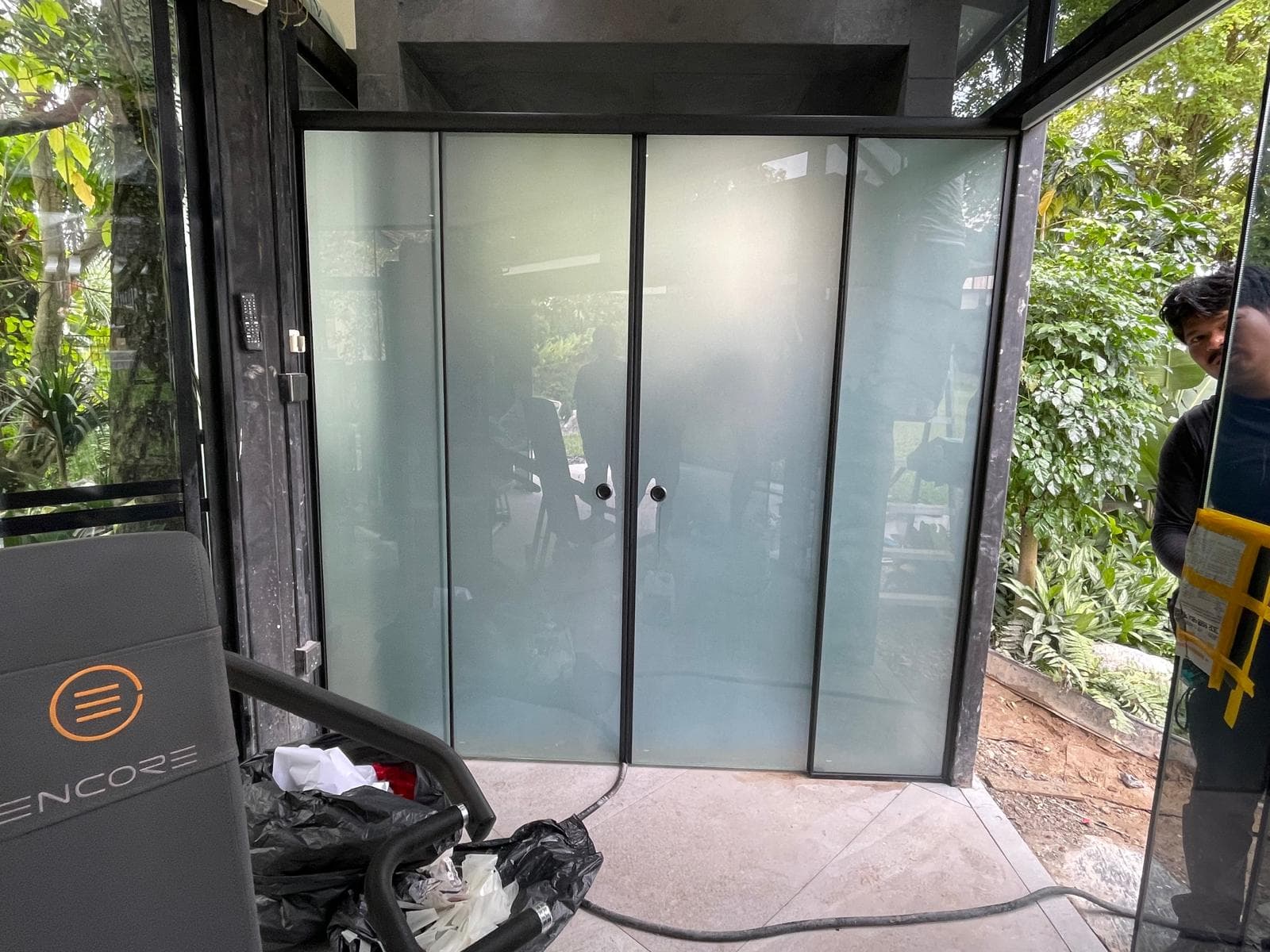 Emergency shopfront glass door board-up at night
