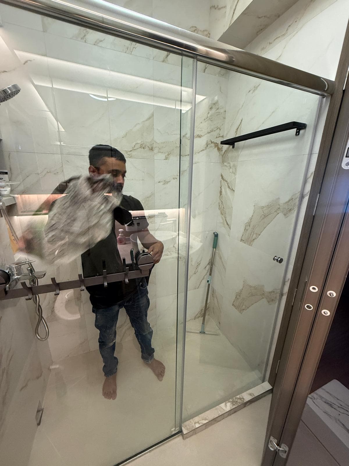 New frameless shower screen glass installation in a modern bathroom