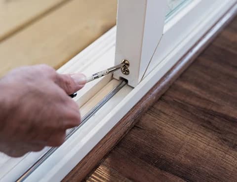 Straightening an aluminium door frame with a mallet